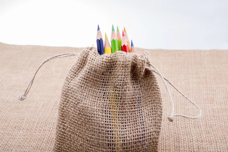 Color Pencils in a linen sack on canvas