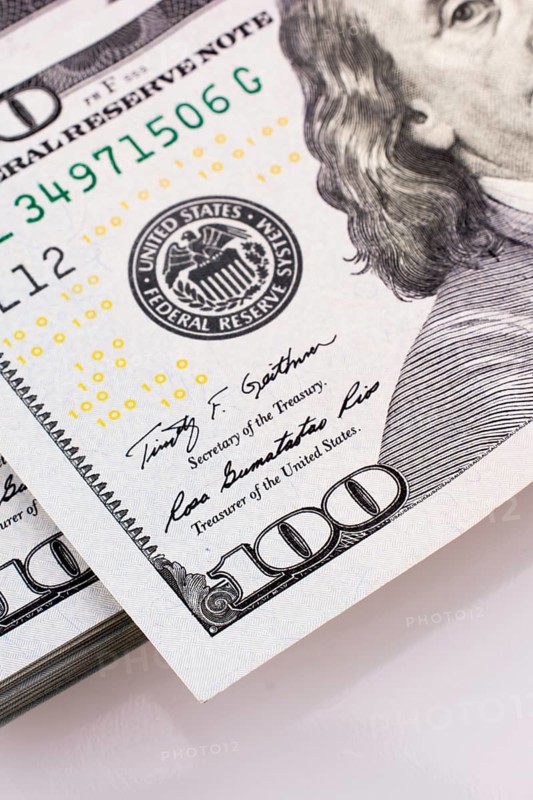 American 100 dollar banknotes made of paper placed on white background