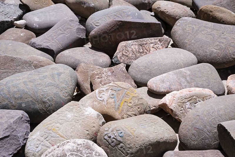 Mani stones with the engraved Tibetan mantra Om Mani Padme Hum