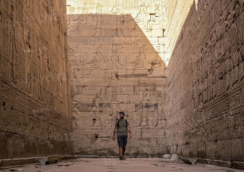 A young tourist visiting the beautiful temple of Edfu in the city of Edfu