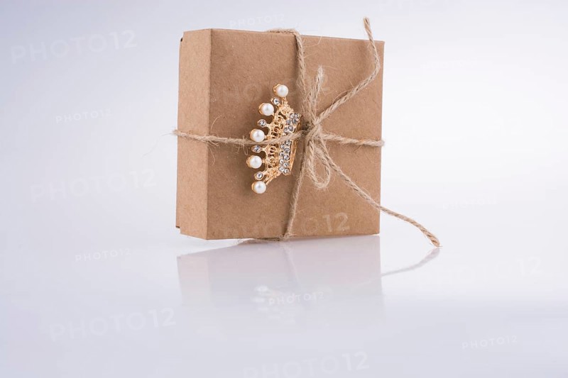 Golden color crown model with pearls on white background