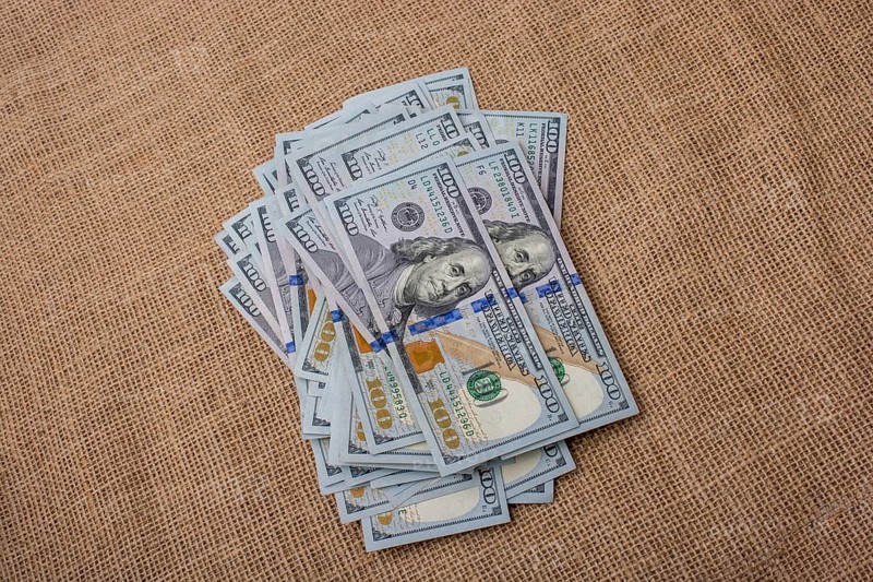 Banknote bundle of US dollar placed on a linen canvas