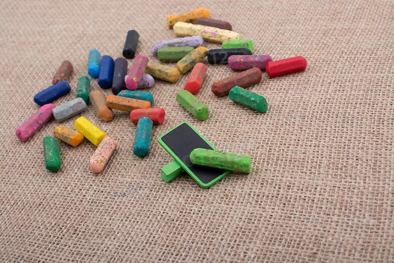 Used crayons of various color and a notice board