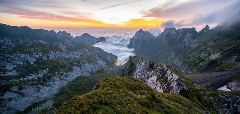 View over Saentis mountains into the valley of Meglisalp at sunrise