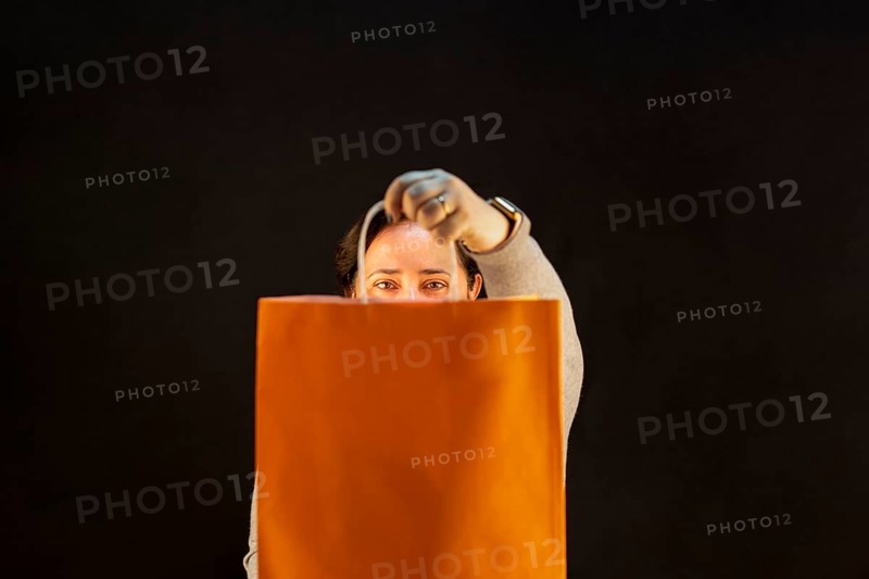 Woman holding shopping bag. Joy of consumption. Purchases