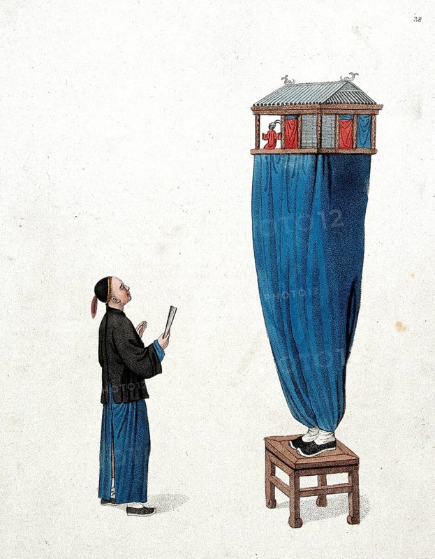 A Chinese puppeteer standing on a stool and balancing a miniature stage above him