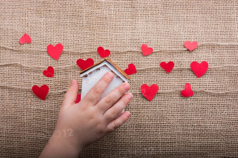 Heart shaped icons and paper house on linen threads