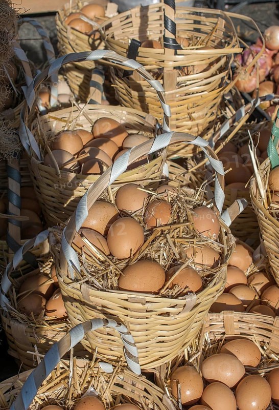 Organic fresh farm eggs in the straw basket