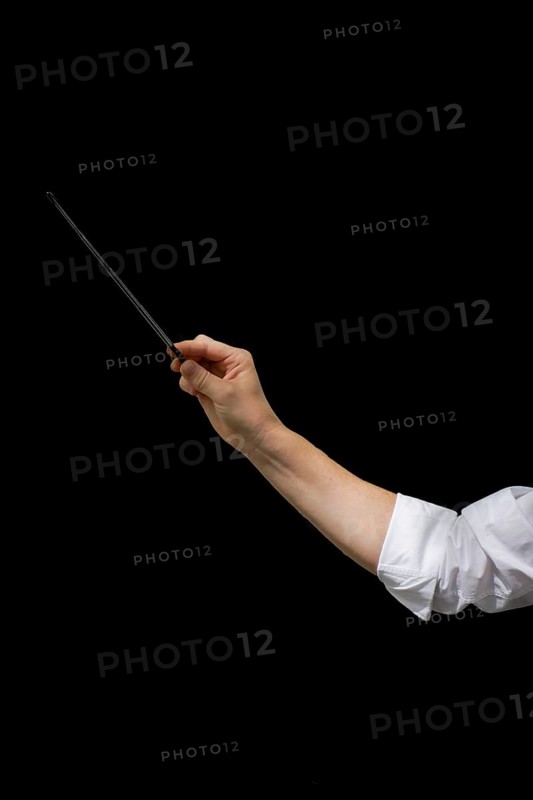 Arm of male conductor with baton isolated on black background