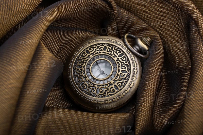 Mechanical retro styled pocket watch on fabric