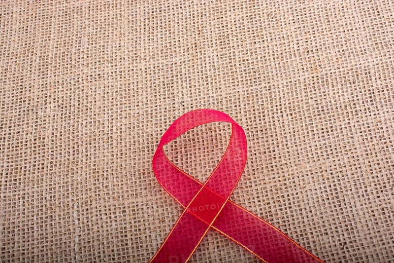 Red band on a brown color linen canvas as a background texture