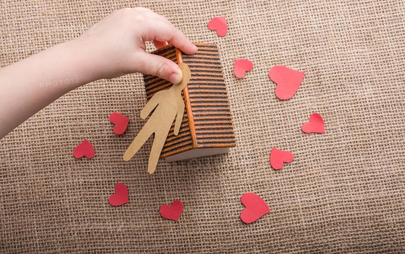 Heart shaped icons and paper house on canvas