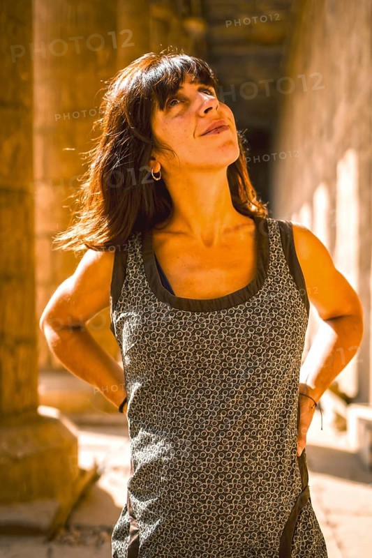 Portrait of a young brunette on the columns of the Edfu Temple near the city of Aswan. Egypt