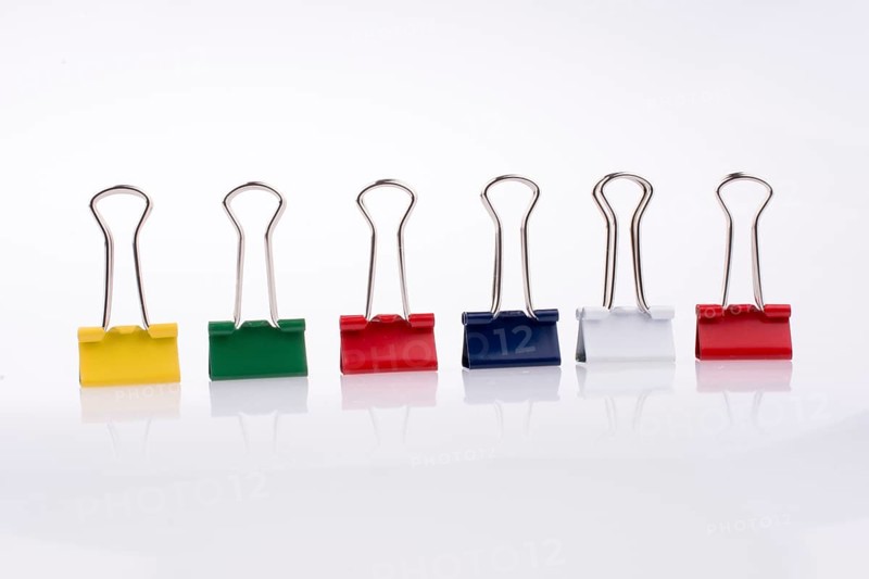 Colored paper clips on a white background