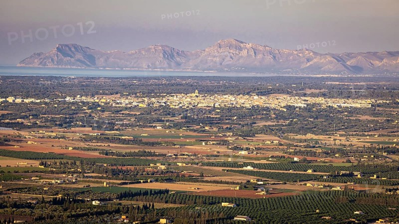 View from mountain Puig Santa Magdalena to the north coast of Majorca with village Muro and peninsula Llevant