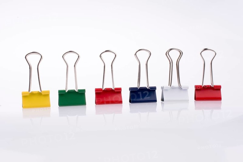 Colored paper clips on a white background