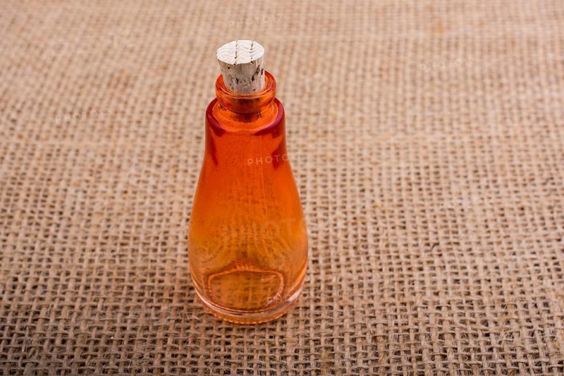 Colorful empty bottle placed on a linen canvas