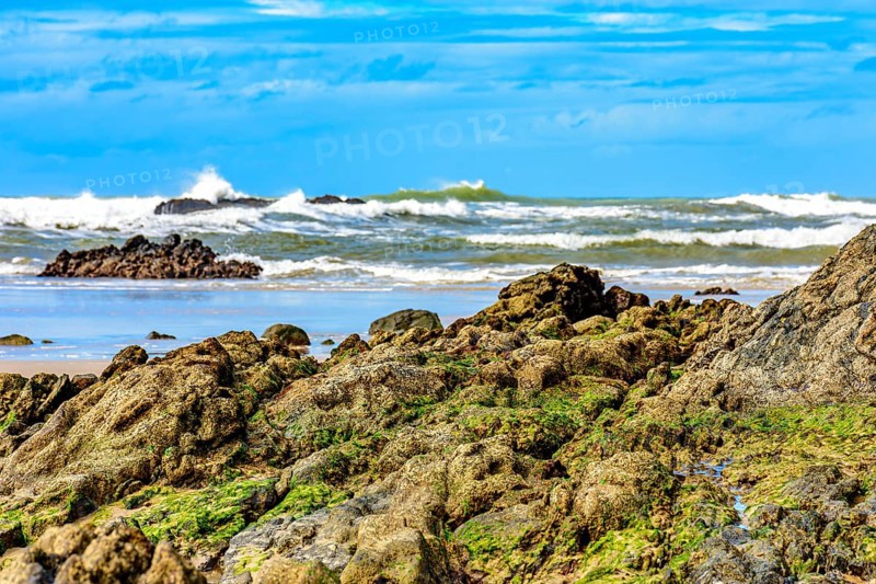 Rocky beach with waves crashing against the rocks in Serra Grande on the coast of Bahia