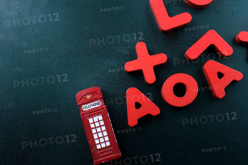 Telephone booth and colorful letters of Alphabet made of wood