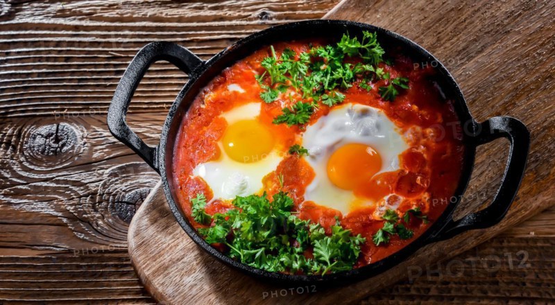 Shakshouka dish in a cast iron pan