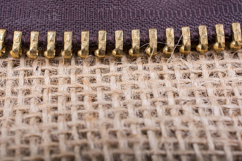 Closeup of a colorful zipper on linen canvas