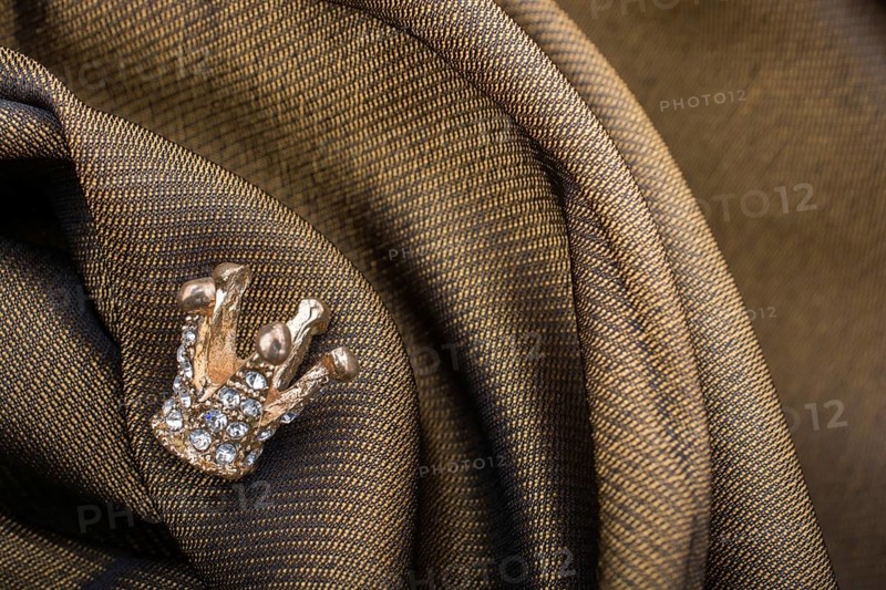 Little model crown placed on a linen canvas