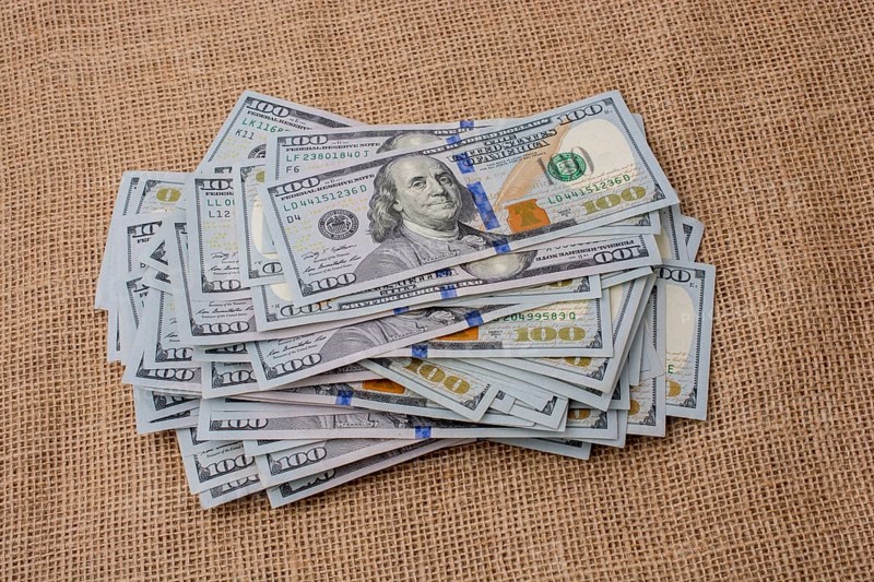 Banknote bundle of US dollar placed on a linen canvas