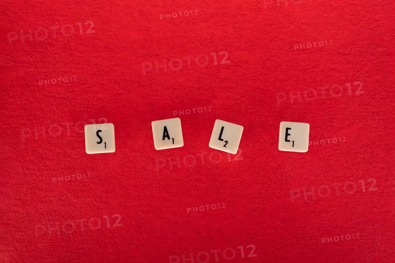 Sale composition. Text on board game chips. Red textured background