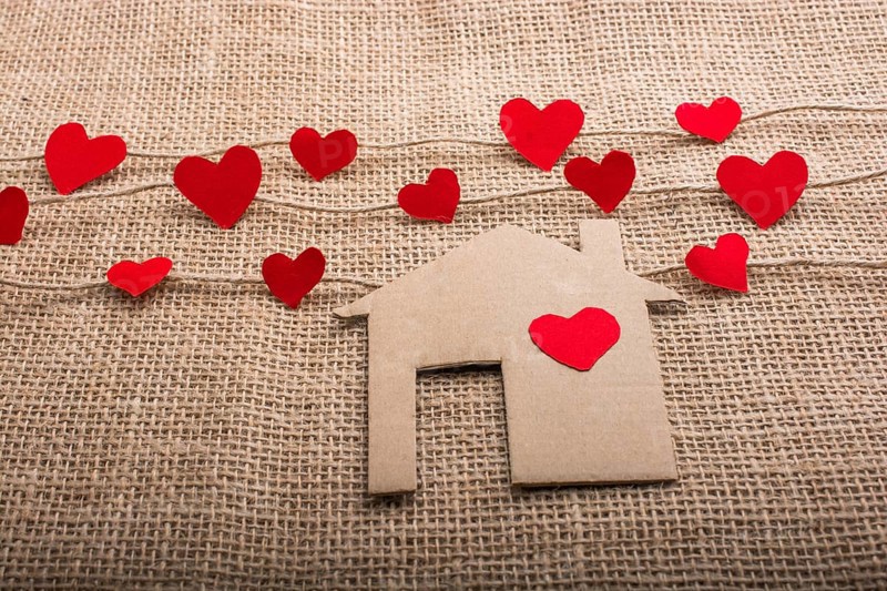 Heart shaped icons and paper house on linen threads