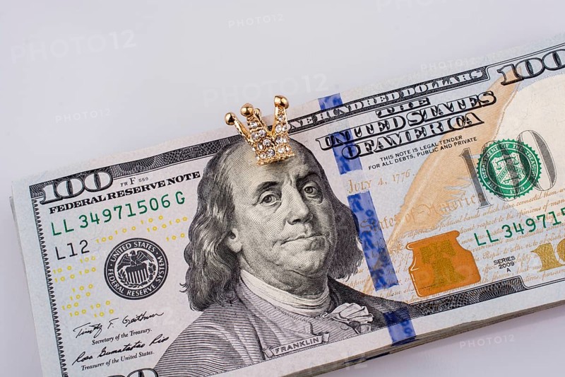 American 100 dollar banknotes and a gold color crown