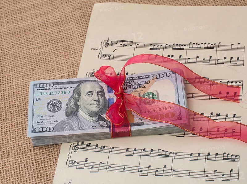 Banknote bundle of US dollar tied with colorful a ribbon