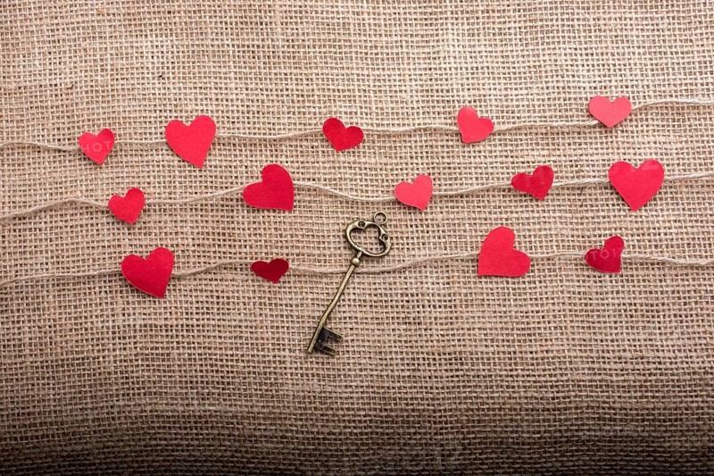 Love concept with heart shaped papers on linen threads