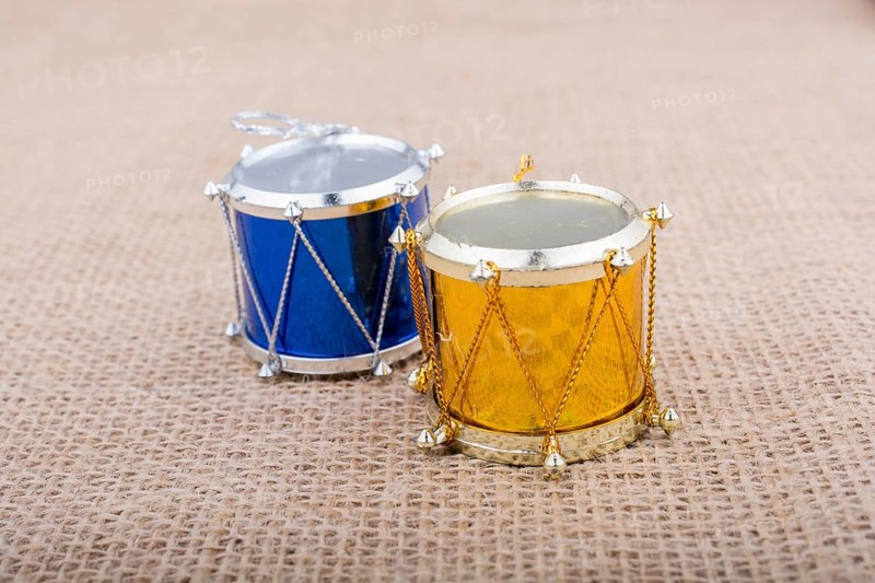 Little colorful toy drums on a canvas background