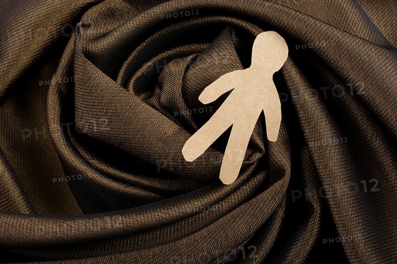 Man shape cut out of paper in hand in the view