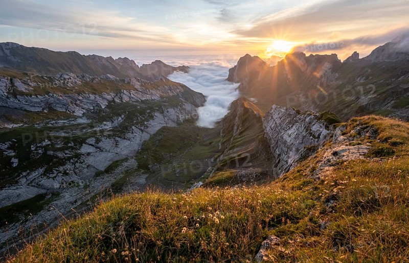 View over Saentis mountains into the valley of Meglisalp at sunrise