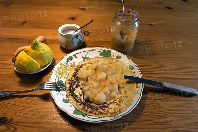 Pancakes with apple sauce and lemon on a plate