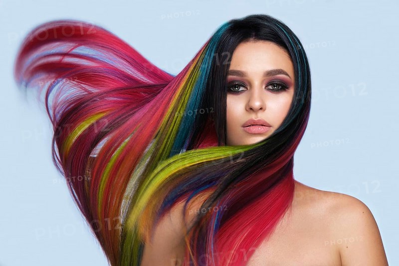 Portrait of beautiful woman with multi-colored hair and creative make up and hairstyle