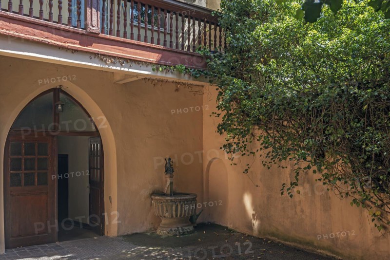Dolphin rider fountain in a historic courtyard