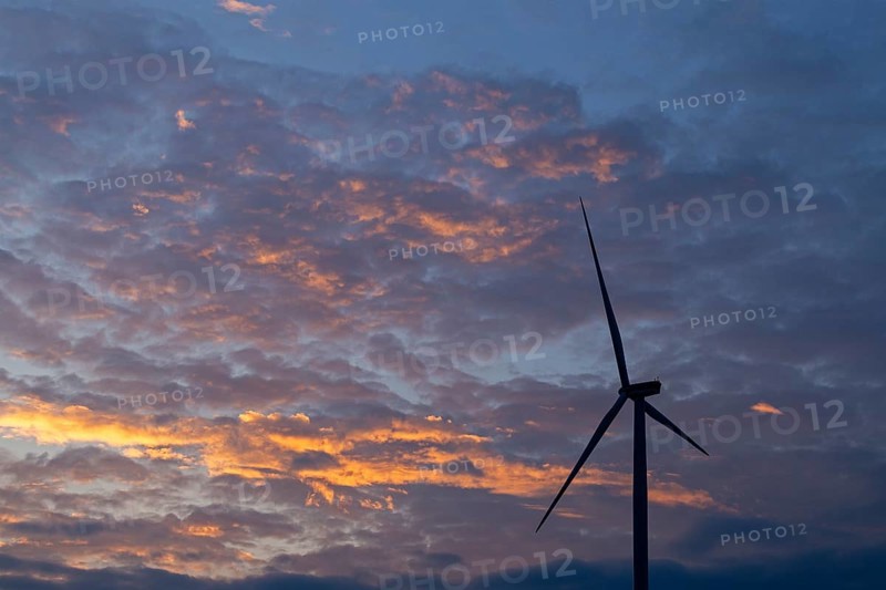 Wind power plant in front of evening sky