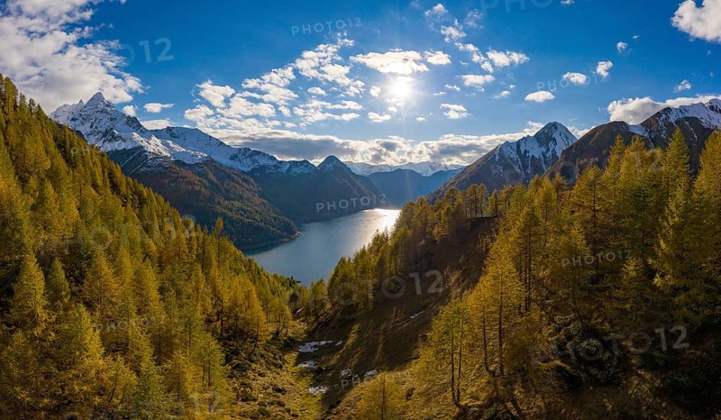 Aerial view over the autumnal forest at Lago di Luzzone in Valle di Blenio
