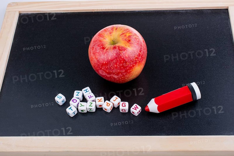 Back to school theme with a red apple and board