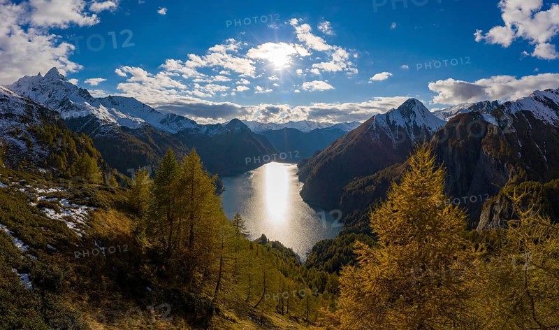 Aerial view over the autumnal forest at Lago di Luzzone in Valle di Blenio
