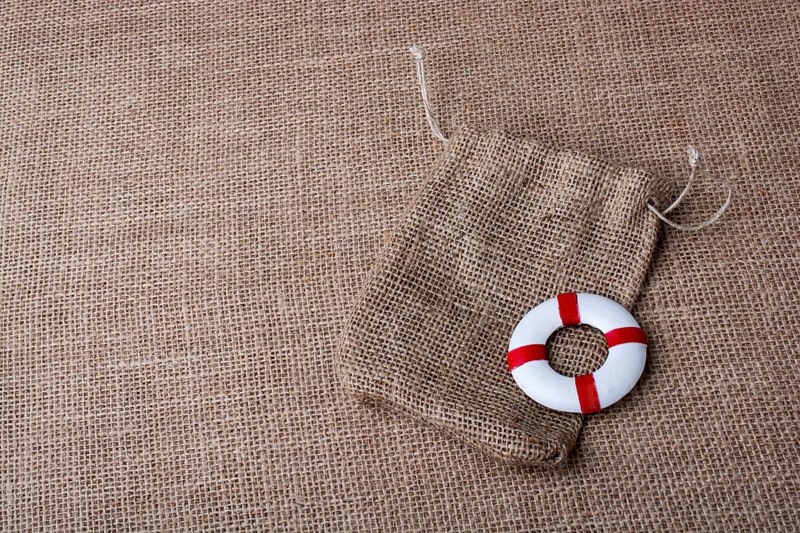 Life preserver on a sack on canvas background