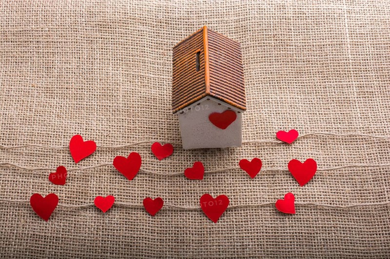 Heart shaped icons and paper house on linen threads