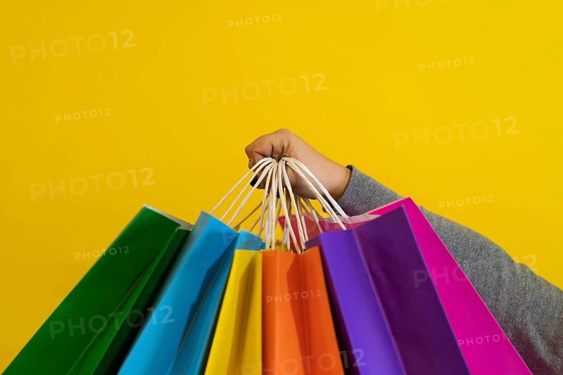 Shopping bags in the woman hands. Joy of consumption. Purchases