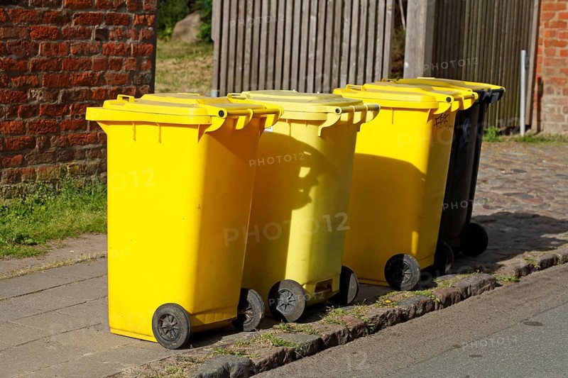 Yellow bins for plastic waste standing on the street