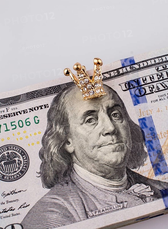 American 100 dollar banknotes and a gold color crown