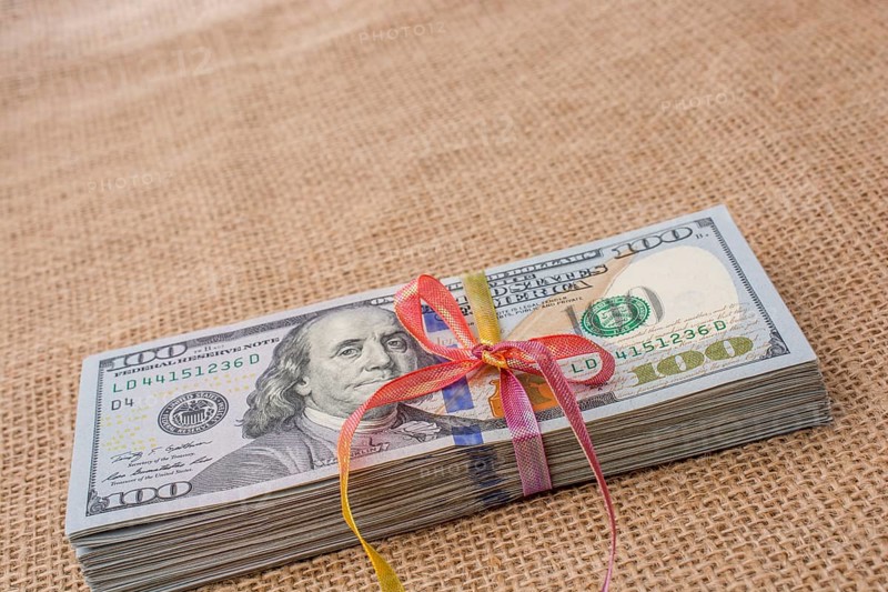 Banknote bundle of US dollar tied with colorful a ribbon