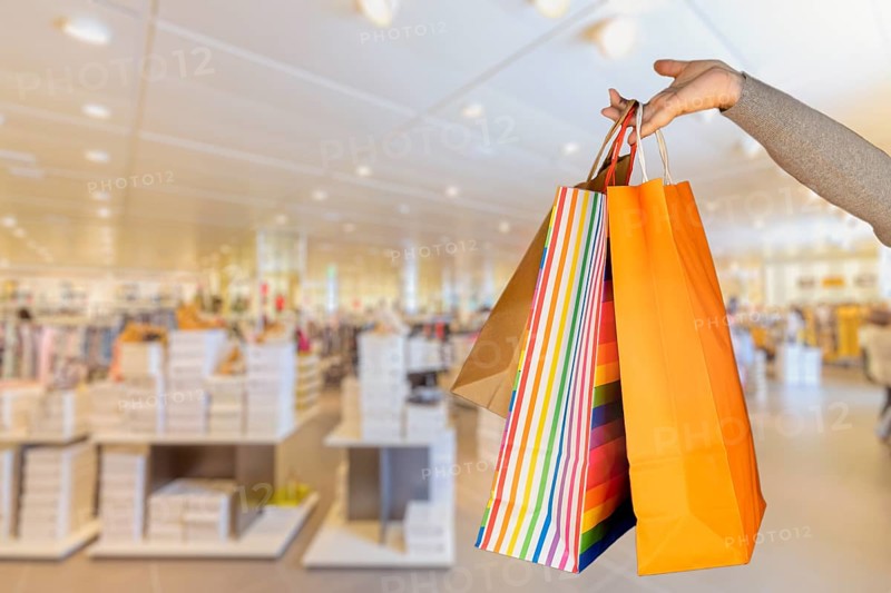 Shopping bags in the woman hands. Joy of consumption. Purchases