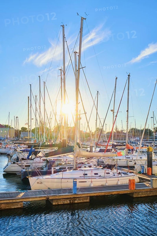 Lisbon marina on Tagus river with moored yachts and boats on sunset. Belem